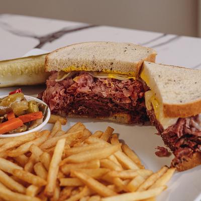 Triple Decker Sandwiches, fries, and peppers on the side.