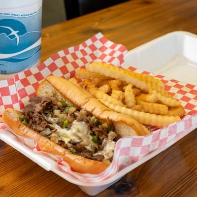 Philly sandwich paired with crinkle cut fries.