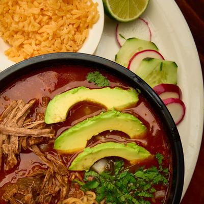 Birria Ramen with avocado, served with rice on the side.