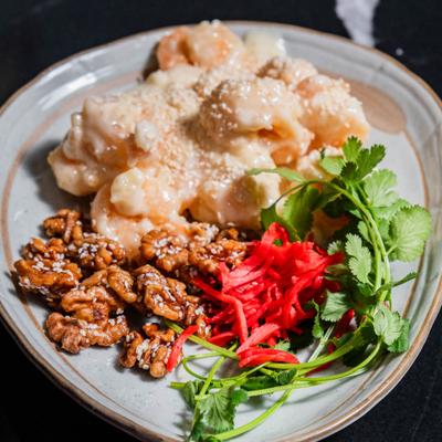 Creamy shrimp with walnuts, herbs, and shredded vegetables.