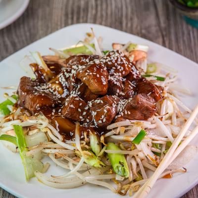 Teriyaki beef served over vegetables.
