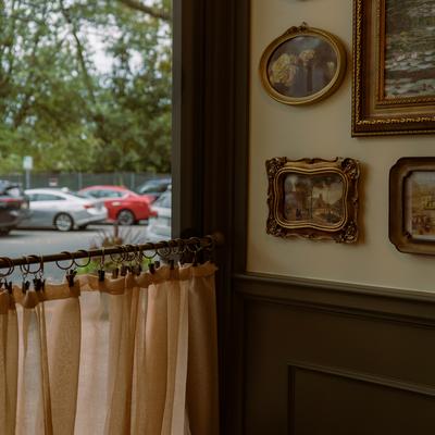 Interior with framed pictures on the walls and a window view.