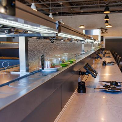 Interior featuring a stainless steel countertop and overhead industrial lighting.