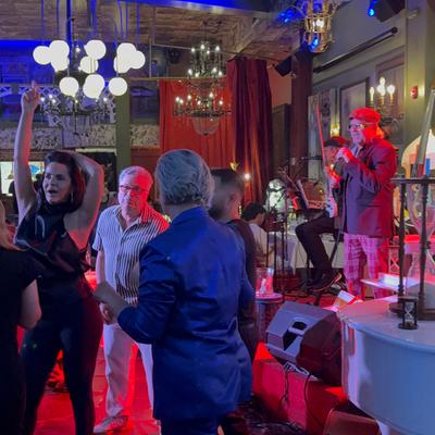 People dancing at night while the musicians play.