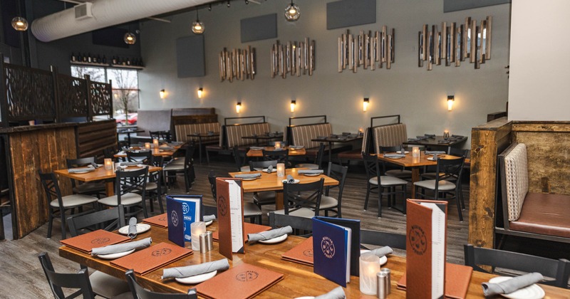 Interior, dining area, tables for four and ten, booths in the back, candle centerpieces