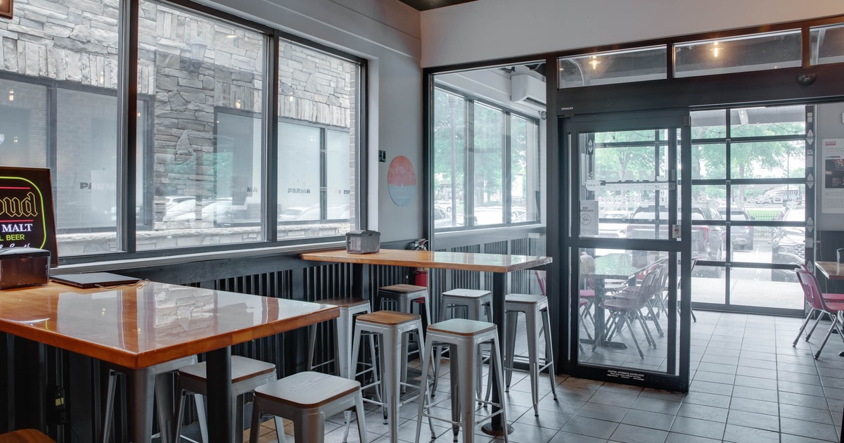 Interior, seating area, high seating tables with stools, tile flooring