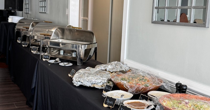 Buffet line with chafing dishes and salads