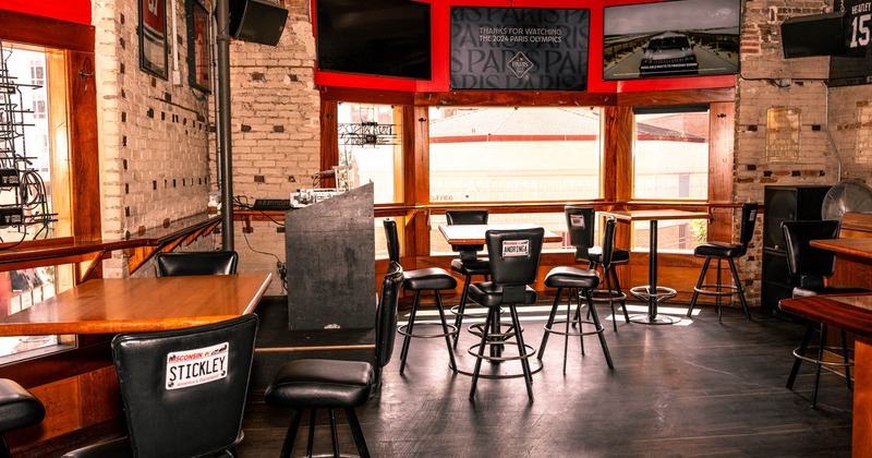 Interior, high seating area, vintage white brick walls, large shop window, sound system