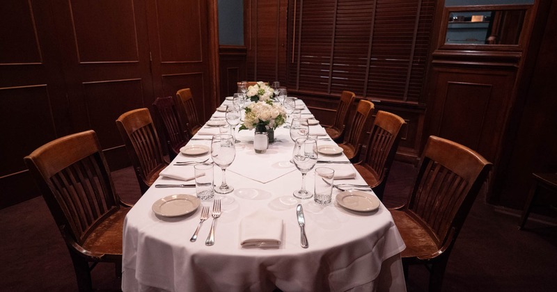 Interior, long set table and chairs ready for guests