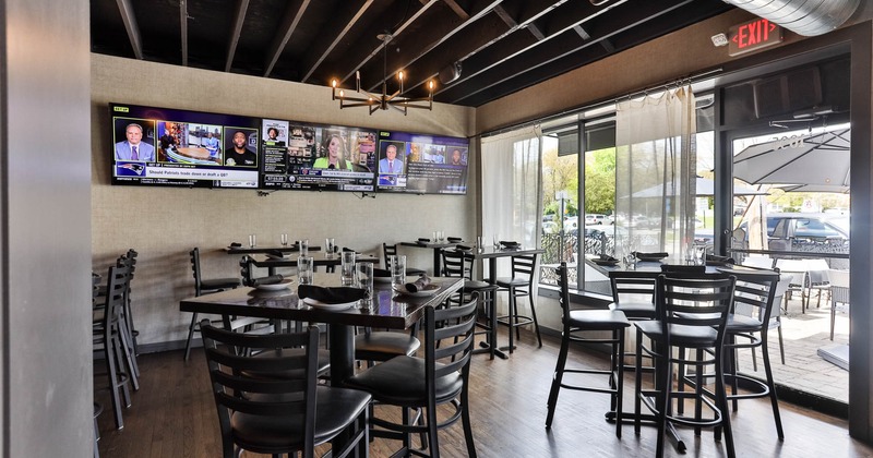 Interior, high seating area, patio exit, large shop windows, TV sets on the wall