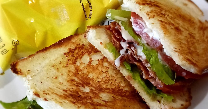 BLT sandwich served with a bag of chips