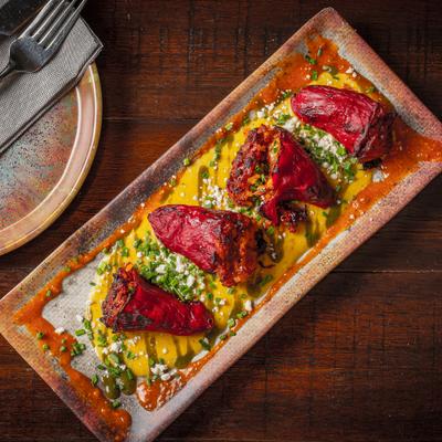 Stuffed piquillo peppers served over creamy sauce.