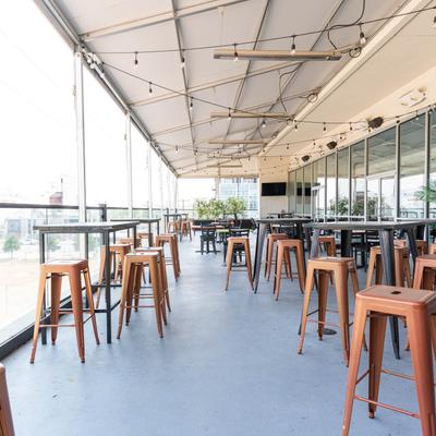 Rooftop terrace, tables and stools.