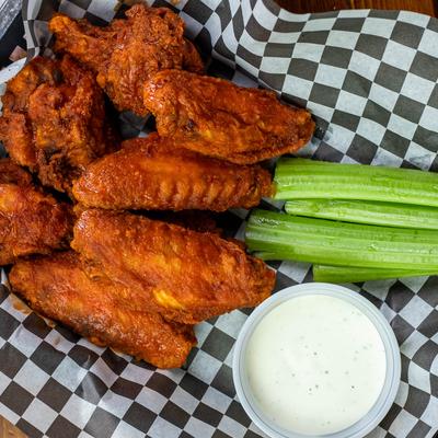 Buffalo Chicken Wings with celery and blue cheese dipping sauce.