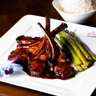 Balsamic Glazed Rack of Lamb served with asparagus.