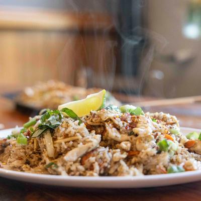 A plate of steaming fried rice.