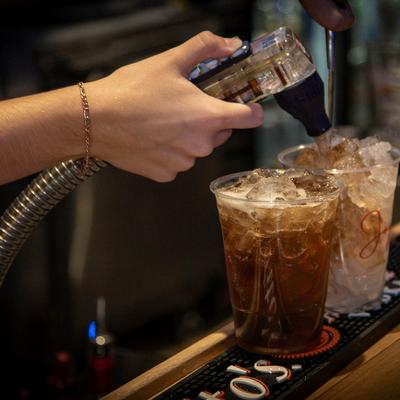 A hand preparing drinks.