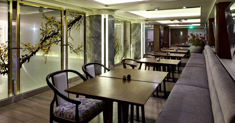 Interior, modern restaurant interior with wooden tables, decorative glass panels, and soft lighting