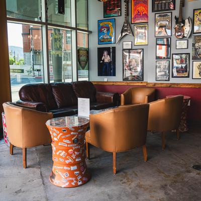 Lounge area nook with sofas, coffee table, armchairs, and a decorated wall.