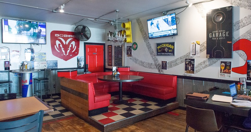 Interior, dining booth in the corner with red upholstered seating