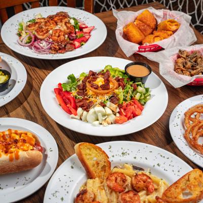 A variety of dishes placed on a wooden table.