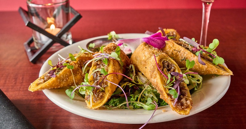 Egg rolls served with cheese sauce with red chili aioli