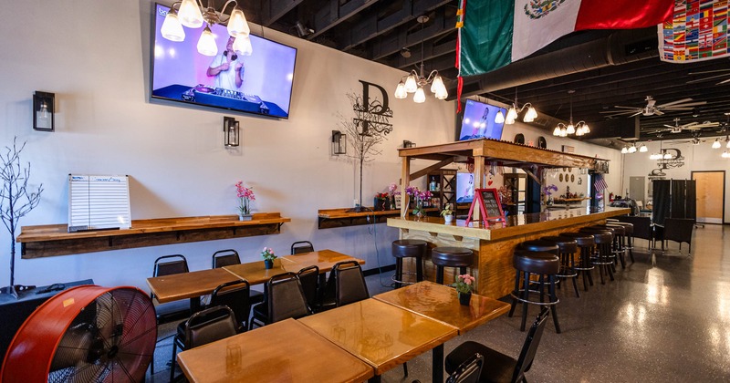 Interior, diner area, tables, chairs, tv screens above
