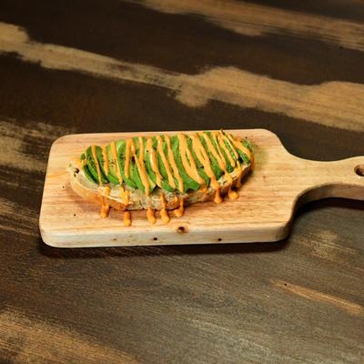 Avocado toast on a wooden board.