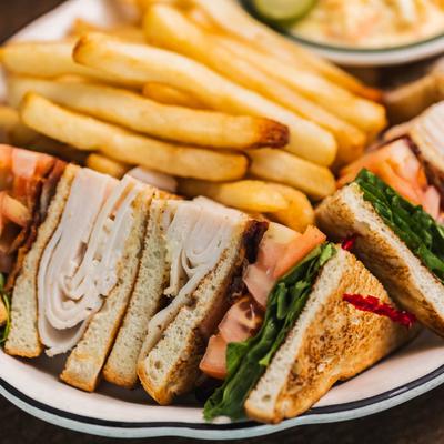 Turkey club with fries on the side.