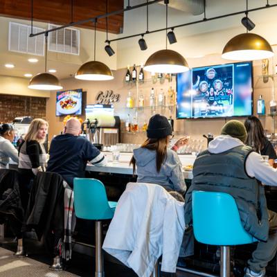 Restaurant bar counter with guests seated.