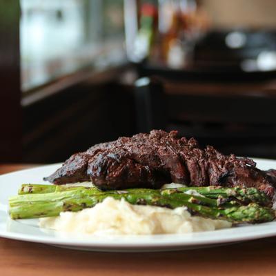 Hanger steak with grilled asparagus and mashed potatoes.
