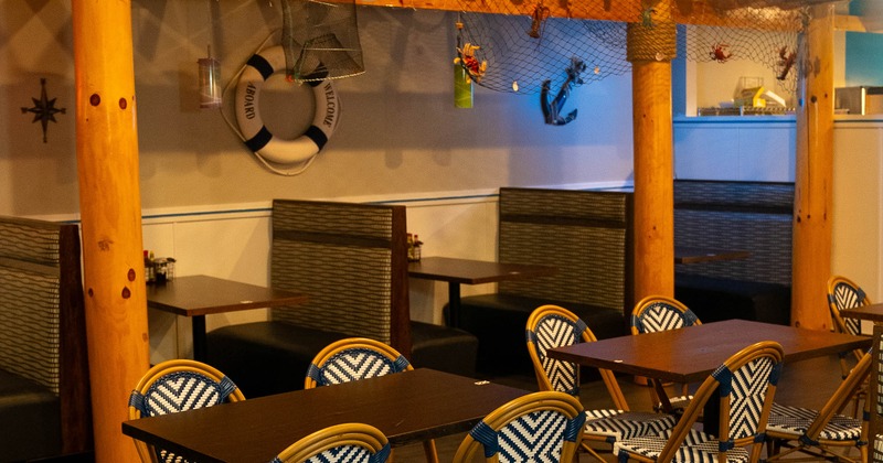 The seating area includes dark wood tables and chairs