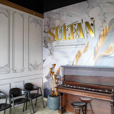Restaurant interior with Sultan sign and piano.