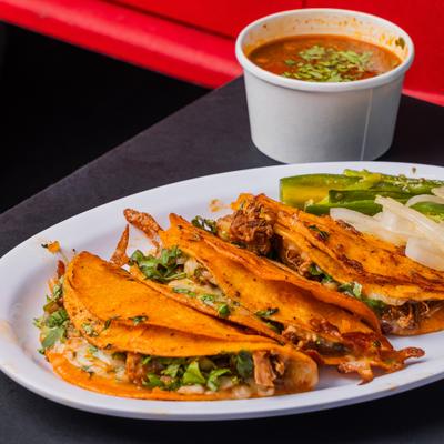 Quesa Birria served with fresh and grilled vegetables and consomee.