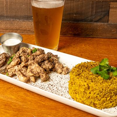 Chicken Shawarma, side of tzatziki and rice, served with beer.