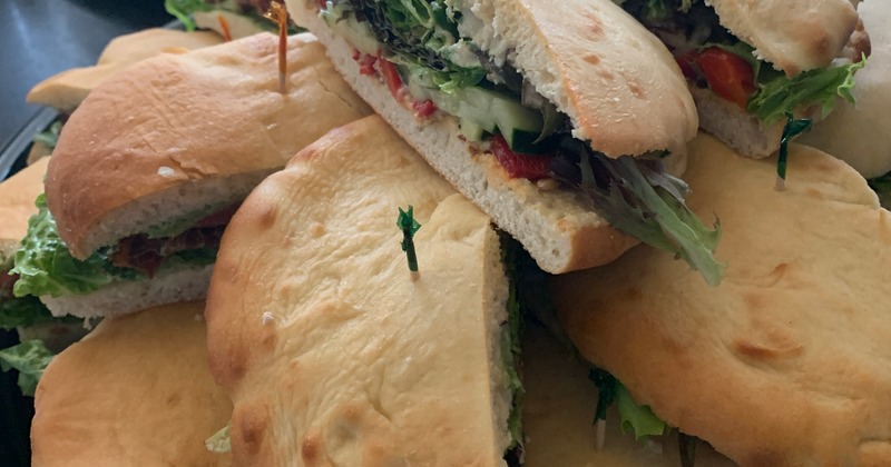 A pile of sandwiches on a tray, close up