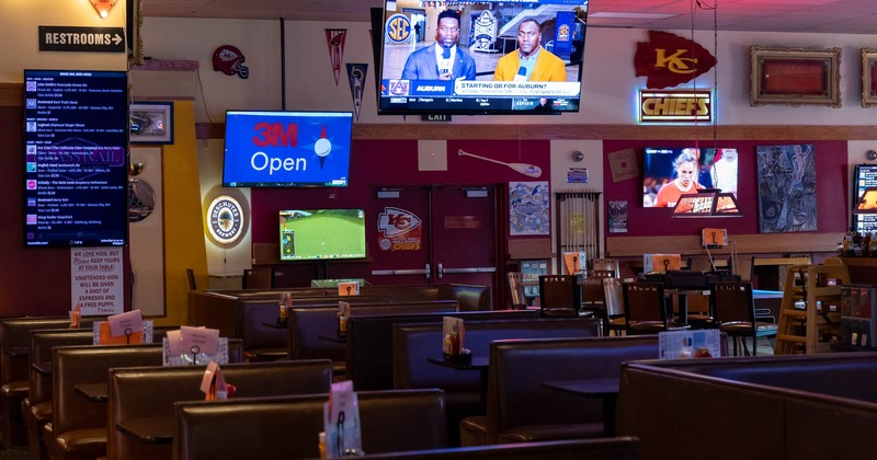 Interior, booth seating area with wall TVs