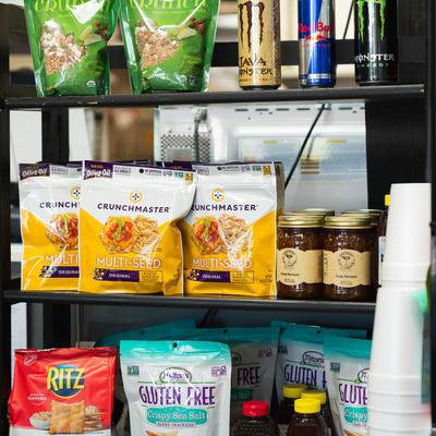 Various drinks and packed goods on shelves.