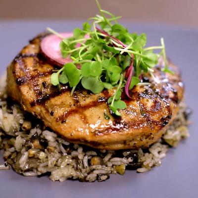 Grilled chicken fillet, on a bed of wild rice, topped with microgreens.