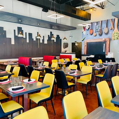 Dining room with booth and standard tables set for guests.