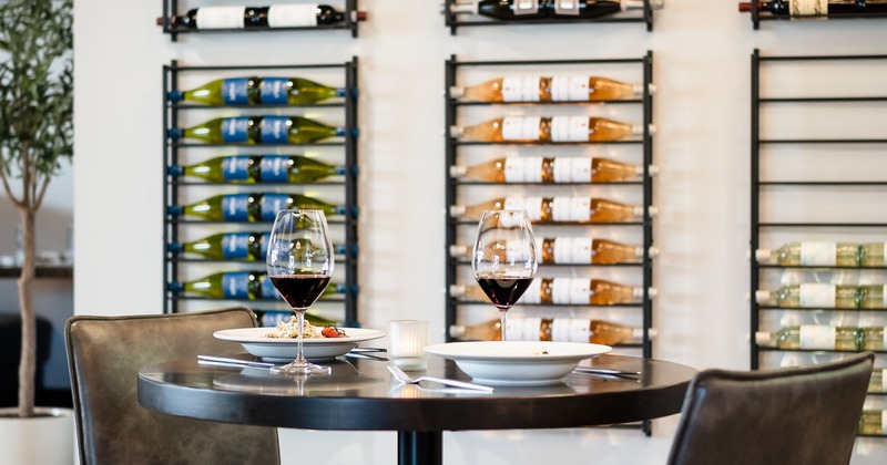 Diner table, wine rack behind