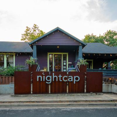 Nightcap restaurant exterior with signage and string lights.