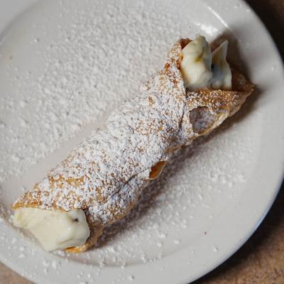Cannoli dusted with powdered sugar.