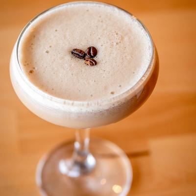 Espresso Martini garnished with three coffee beans.