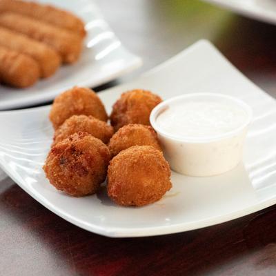 Mac and cheese bites served with a dipping sauce.
