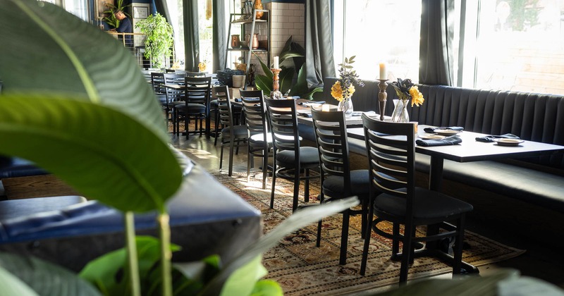 Interior, tables set for guests in dining area