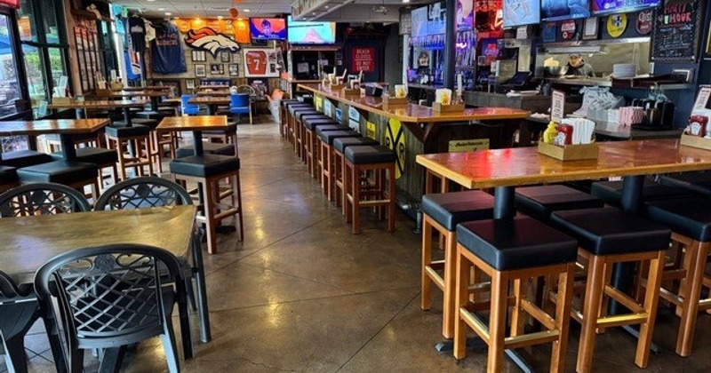 Interior, dining area, tables, chairs, benches and a bar