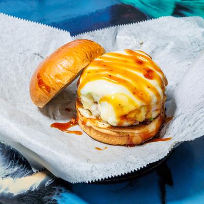 Hawaiian burger topped with grilled pineapple, melted cheese and a sauce drizzle.