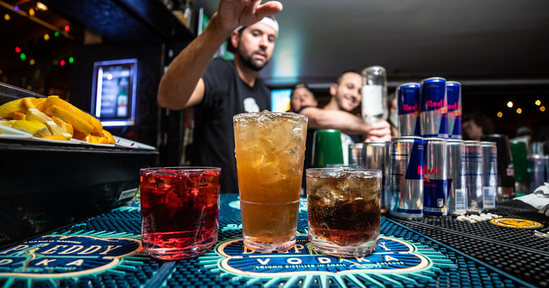 Employee making three different types of cocktail