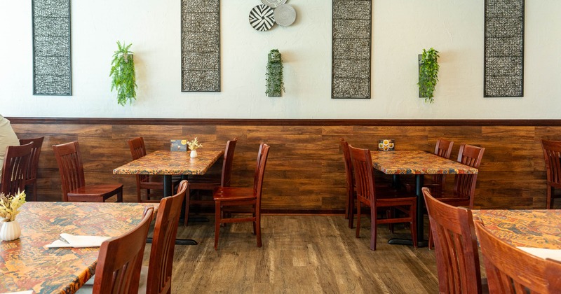 A cozy restaurant interior with wooden floors and tables